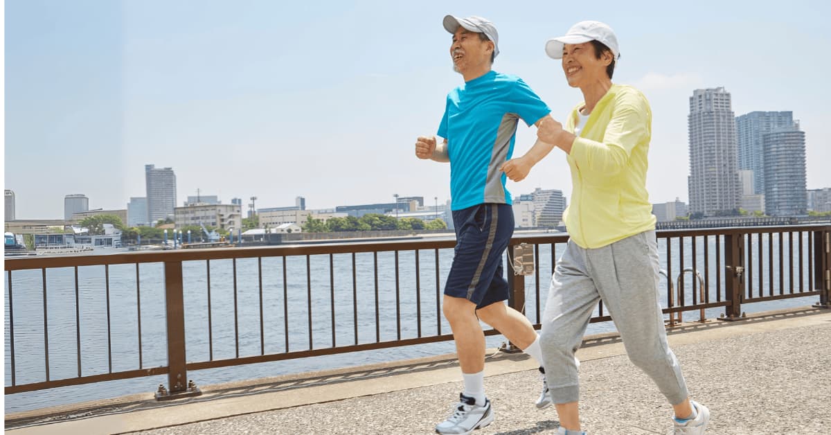 Active senior couple enjoying a healthy lifestyle through daily exercise Older couple walking outdoors for regular exercise to maintain good health
