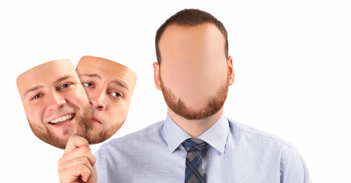 Person holding different facial masks showing happy and sad emotions, representing hidden depression and masking mental health struggles.