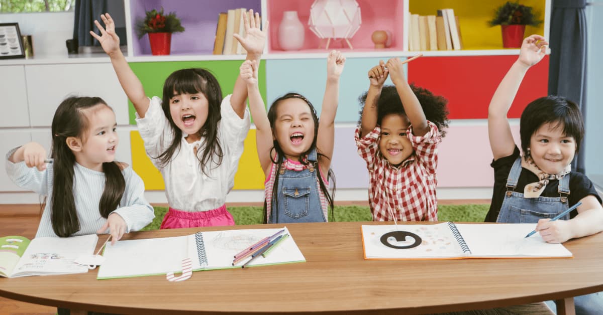 Children happily learning in a classroom, representing supportive environments for students who may experience seizures.