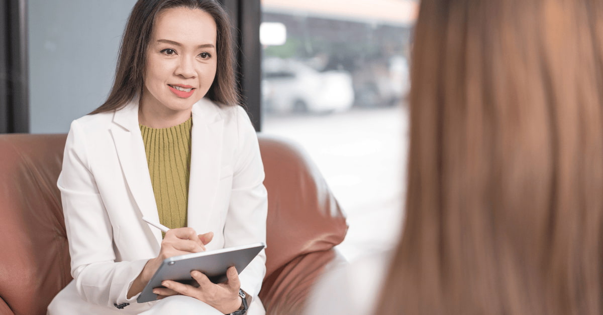 Psychiatrist consulting a patient about schizophrenia symptoms and mental health treatment