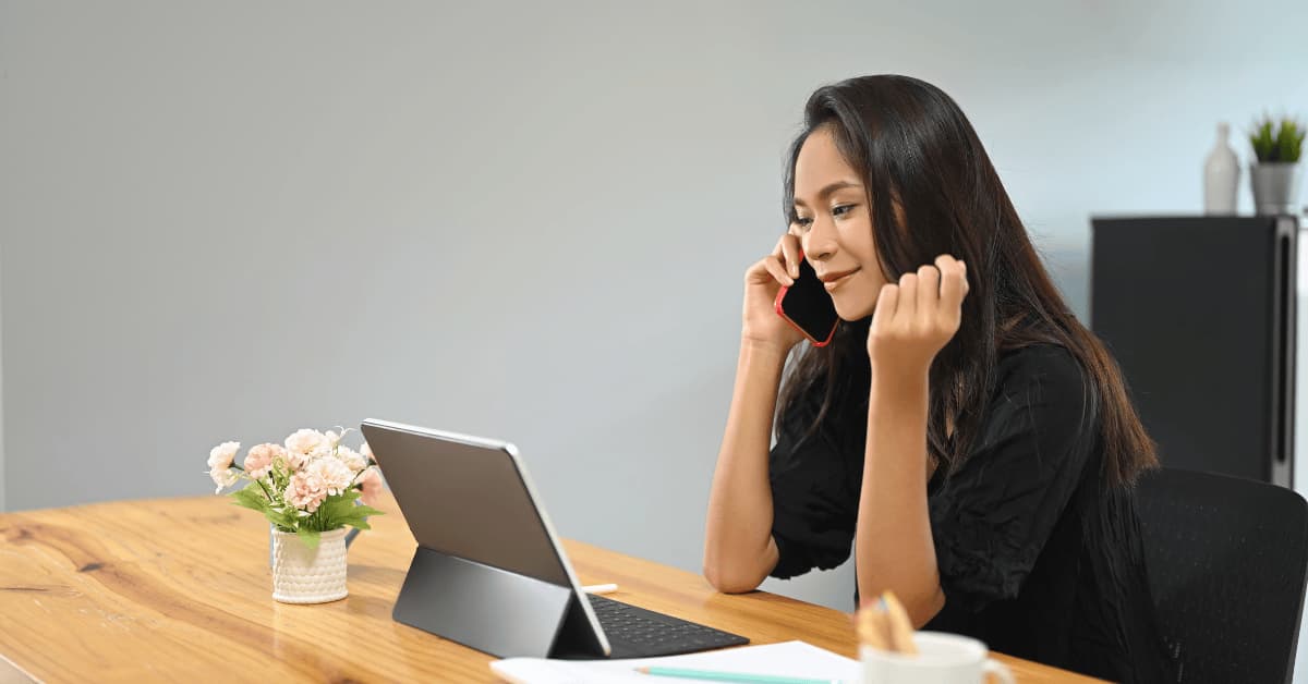 Woman using a tablet and phone, activities that may increase eye strain and contribute to dry eye symptoms.