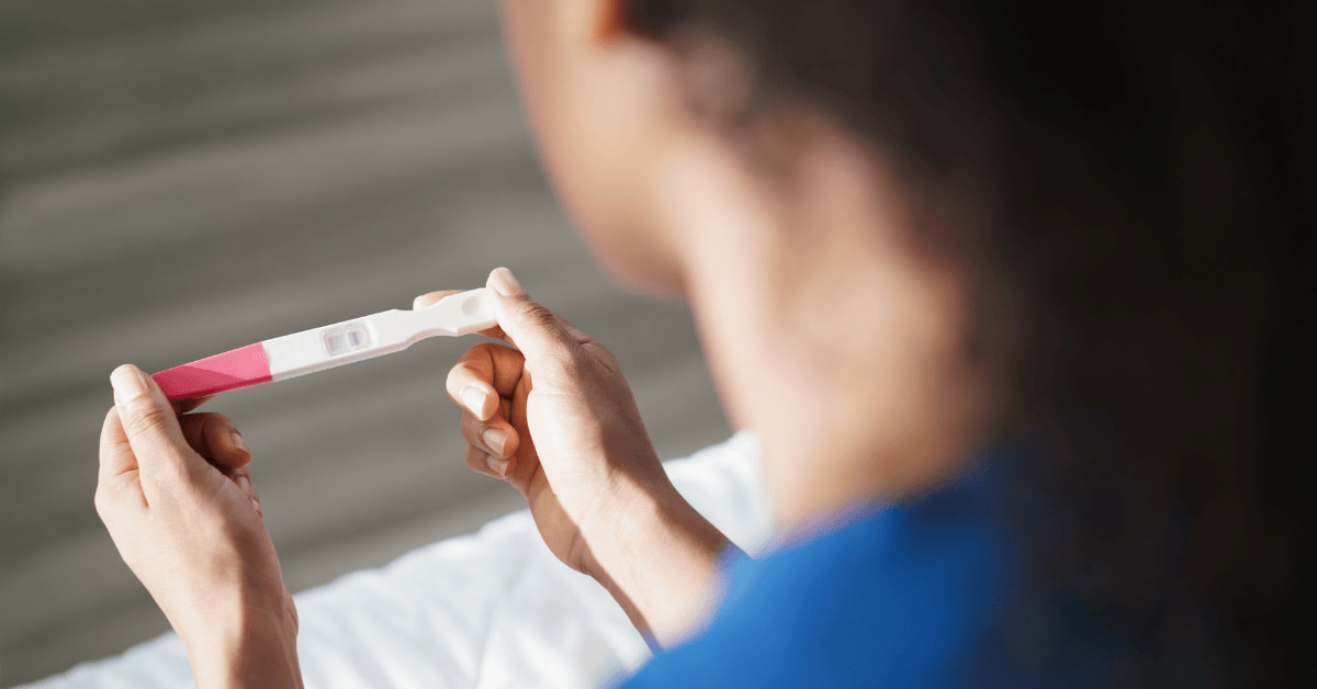 “Woman checking a pregnancy test before starting progesterone pills